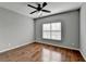 Spacious bedroom with hardwood floors and ceiling fan at 490 La Perla Dr, Sugar Hill, GA 30518