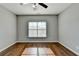 Bright bedroom featuring hardwood floors and a large window at 490 La Perla Dr, Sugar Hill, GA 30518