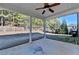 Covered patio overlooks fenced backyard with trees at 490 La Perla Dr, Sugar Hill, GA 30518