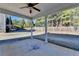 Covered patio overlooks fenced backyard with trees at 490 La Perla Dr, Sugar Hill, GA 30518