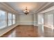 Spacious dining room with hardwood floors, chandelier, and large windows at 490 La Perla Dr, Sugar Hill, GA 30518