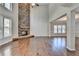 High-ceiling great room with hardwood floors, stone fireplace, and large windows at 490 La Perla Dr, Sugar Hill, GA 30518