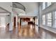 Open concept great room with kitchen, hardwood floors, and a curved staircase at 490 La Perla Dr, Sugar Hill, GA 30518