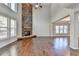 High-ceiling great room with hardwood floors, stone fireplace, and large windows at 490 La Perla Dr, Sugar Hill, GA 30518