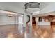Open floor plan with hardwood floors, kitchen, dining, and a curved staircase at 490 La Perla Dr, Sugar Hill, GA 30518