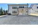 House exterior showcasing covered patio and yard at 490 La Perla Dr, Sugar Hill, GA 30518