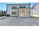 House exterior showcasing covered patio and yard at 490 La Perla Dr, Sugar Hill, GA 30518
