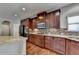 Modern kitchen with granite countertops and dark wood cabinets at 490 La Perla Dr, Sugar Hill, GA 30518
