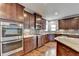 Modern kitchen featuring stainless steel appliances and dark wood cabinets at 490 La Perla Dr, Sugar Hill, GA 30518