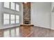 Spacious living room featuring hardwood floors and a large stone fireplace at 490 La Perla Dr, Sugar Hill, GA 30518
