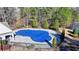 Community pool with blue cover and black fence at 490 La Perla Dr, Sugar Hill, GA 30518