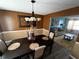 Formal dining room with a dark wood table and chandelier at 1224 Labrador Ln, Riverdale, GA 30296