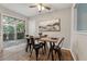 Dining area with wooden table and black metal chairs near sliding door at 1259 Mill Lake Cir, Stone Mountain, GA 30088