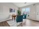 Sunlit dining area with a wooden table and two teal chairs at 1259 Mill Lake Cir, Stone Mountain, GA 30088