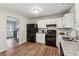 Updated kitchen featuring black appliances and white cabinets at 1259 Mill Lake Cir, Stone Mountain, GA 30088