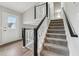 Modern staircase with a white and black railing leading to the second floor at 1259 Mill Lake Cir, Stone Mountain, GA 30088