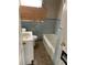 Bathroom with light blue tiled walls, bathtub, and toilet at 2725 Blount St, East Point, GA 30344