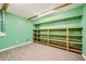 Finished basement room with green walls and shelving at 3580 Bulloch Lake Rd, Loganville, GA 30052