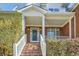 Brick front entrance with white columns and steps leading to the door at 3580 Bulloch Lake Rd, Loganville, GA 30052