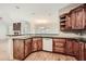 Kitchen with dark wood cabinets, granite countertops, and island at 3580 Bulloch Lake Rd, Loganville, GA 30052