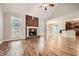 Living room with hardwood floors, a fireplace, and an open floor plan at 3580 Bulloch Lake Rd, Loganville, GA 30052