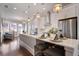 Open concept kitchen with white cabinets, quartz countertops, and stainless steel appliances at 6736 Cadence Blvd, Sandy Springs, GA 30328