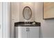 Modern powder room with dark vanity and oval mirror at 6736 Cadence Blvd, Sandy Springs, GA 30328