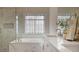 Stunning bathroom with a glass shower, garden tub, white cabinets, dual sinks, and marble accents at 366 Greycoat Sw Blf, Marietta, GA 30064