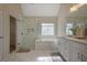 Beautiful bathroom features marble floors, a glass shower, a garden tub, and dual sinks at 366 Greycoat Sw Blf, Marietta, GA 30064