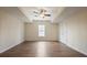 This bright bedroom features hardwood floors, a ceiling fan, and a large window at 366 Greycoat Sw Blf, Marietta, GA 30064