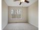 Bedroom with soft carpet, ceiling fan, and a bright window with a wooded view at 366 Greycoat Sw Blf, Marietta, GA 30064