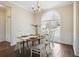 Elegant dining room featuring hardwood floors, a large window, and wainscoting details at 366 Greycoat Sw Blf, Marietta, GA 30064