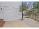 Exterior of the garage featuring stylish carriage doors and manicured shrubbery at 366 Greycoat Sw Blf, Marietta, GA 30064