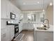 Modern kitchen with white cabinets, stainless steel appliances, and a cozy breakfast nook at 366 Greycoat Sw Blf, Marietta, GA 30064