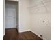 Laundry room with wood floors and wire shelving above a utility hookup at 366 Greycoat Sw Blf, Marietta, GA 30064