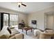 Bright living room with a ceiling fan, hardwood floors, and a balcony with views of the surrounding trees at 366 Greycoat Sw Blf, Marietta, GA 30064