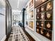 Hallway decorated with a series of framed artwork with dark wood flooring and patterned area rug at 1065 Peachtree Ne St # 3102, Atlanta, GA 30309
