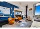 Open-concept living room with city views features unique art and comfortable contemporary furnishings at 1065 Peachtree Ne St # 3102, Atlanta, GA 30309