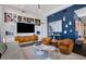 Cozy living room features modern furnishings, television, and unique wall decor in luxury home at 1065 Peachtree Ne St # 3102, Atlanta, GA 30309
