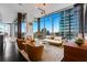 The living room boasts floor-to-ceiling windows with city views, and sleek, modern furniture at 1065 Peachtree Ne St # 3102, Atlanta, GA 30309