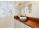 Bright bathroom with white vanity, vessel sink, wood countertop, and natural light at 2993 Saint Annes Nw Ln, Atlanta, GA 30327