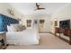 Calm main bedroom suite with a plush bed, ceiling fan, and natural light from multiple windows at 2993 Saint Annes Nw Ln, Atlanta, GA 30327