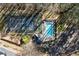 Aerial view of a community pool and tennis court surrounded by mature trees at 3300 Greencastle Chase Ne, Marietta, GA 30062