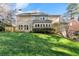 Large grassy backyard of the home, surrounded by mature trees, with a full wall of windows at 3300 Greencastle Chase Ne, Marietta, GA 30062