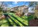 Sloping backyard with lush green grass, garden beds and deck leading up to home at 3300 Greencastle Chase Ne, Marietta, GA 30062