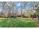 Expansive grassy backyard with trees surrounding the property, and a storage shed at 3300 Greencastle Chase Ne, Marietta, GA 30062
