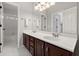 Bathroom features a double sink, brown cabinets, a large mirror and a shower at 3300 Greencastle Chase Ne, Marietta, GA 30062