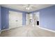 Bedroom showcasing neutral carpeting, light blue walls, walk-in closet and interior door to bath at 3300 Greencastle Chase Ne, Marietta, GA 30062