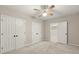 Bedroom with neutral walls, carpet, three doors, and a ceiling fan at 3300 Greencastle Chase Ne, Marietta, GA 30062