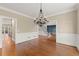 Dining room with hardwood floors, chandelier, and views to the foyer and kitchen at 3300 Greencastle Chase Ne, Marietta, GA 30062
